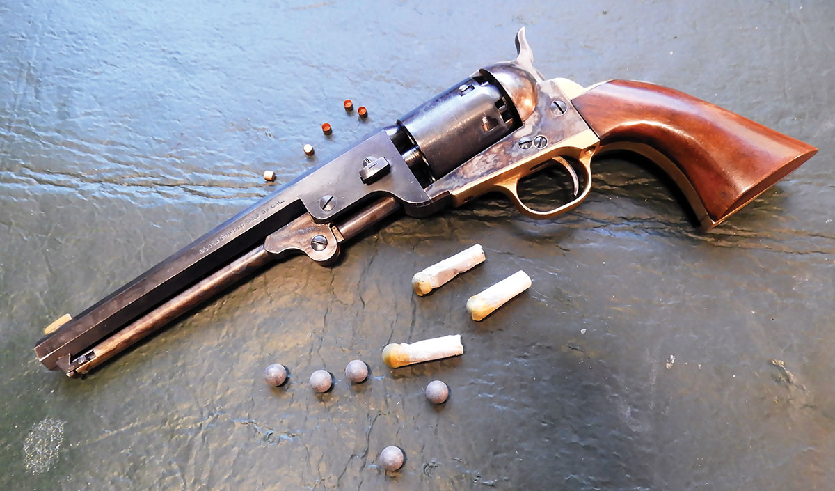An Italian-made reproduction 1851 Navy Colt pictured with 36-caliber round balls and pre-charged paper loads. A lot of blackpowder hunters have revolvers because they are interesting and are a link with  Civil War history, the Indian wars, cattle battles and the westward  expansion of the late 1800s.